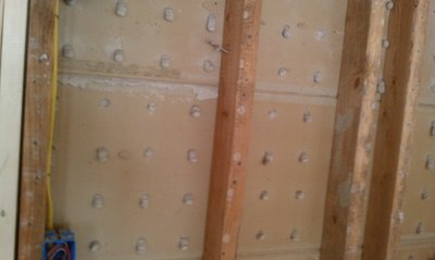 Perforated rock lath, also called button board.