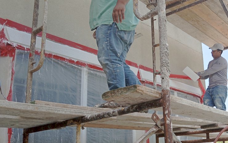 Bands over windows hide the stucco repair