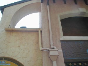 gutters
                  and downspouts on cement stucco