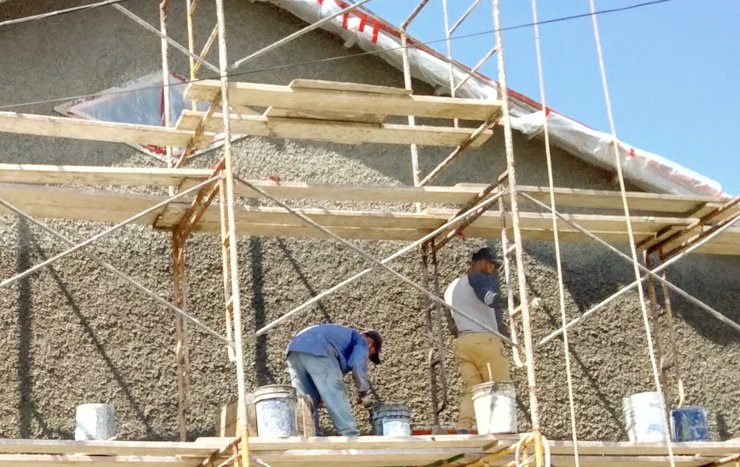 Pebble dash stucco matches original 1908 building exactly.